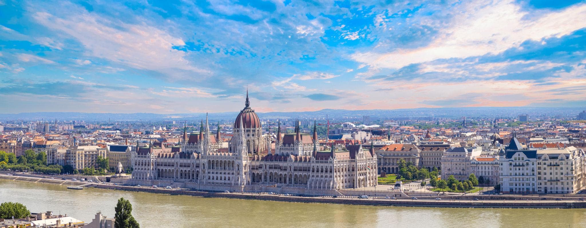 Panoramic view of the Hungarian Parliament Building along the Danube River in Budapest, Hungary.